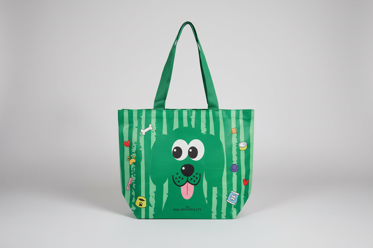 Green tote bag with a cartoon dog design on a white surface
